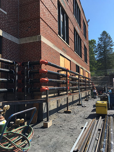 Racks for temporary utility lines have been installed on south wall of ...
