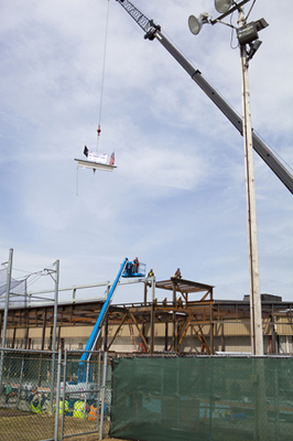 Schneider Arena beam being hoisted up