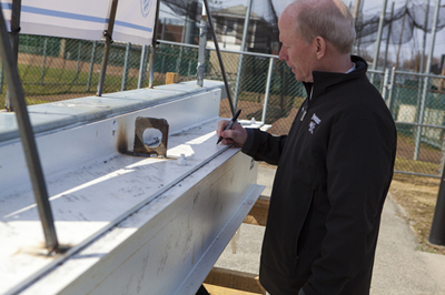 Fr. Shanley signing the beam of Schneider Arena